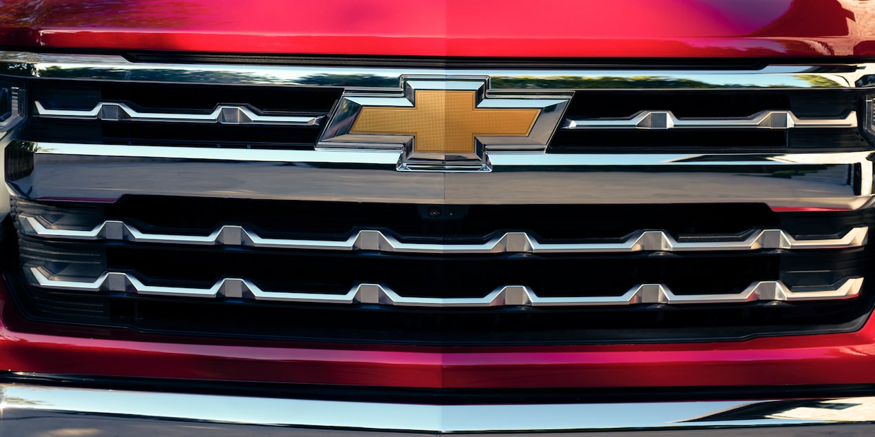 Close-up of the Chevy Logo on A Red 2025 Chevy Silverado Grille