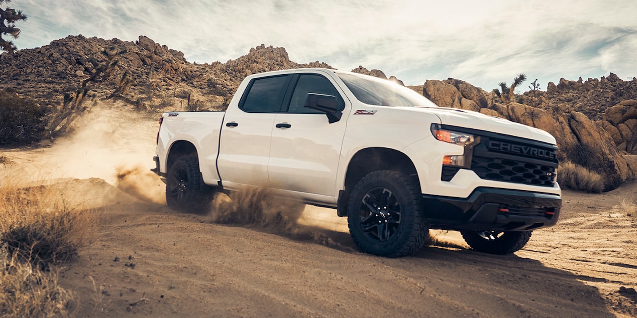 Three Quarters View of a White Silverado under a Sunny Weather on a Desert