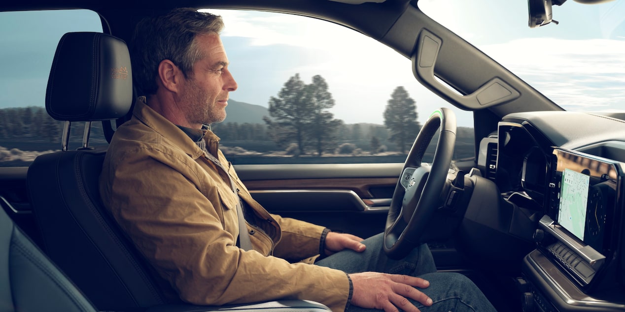A Man Enjoying the Connected Services Technology of his 2025 Silverado