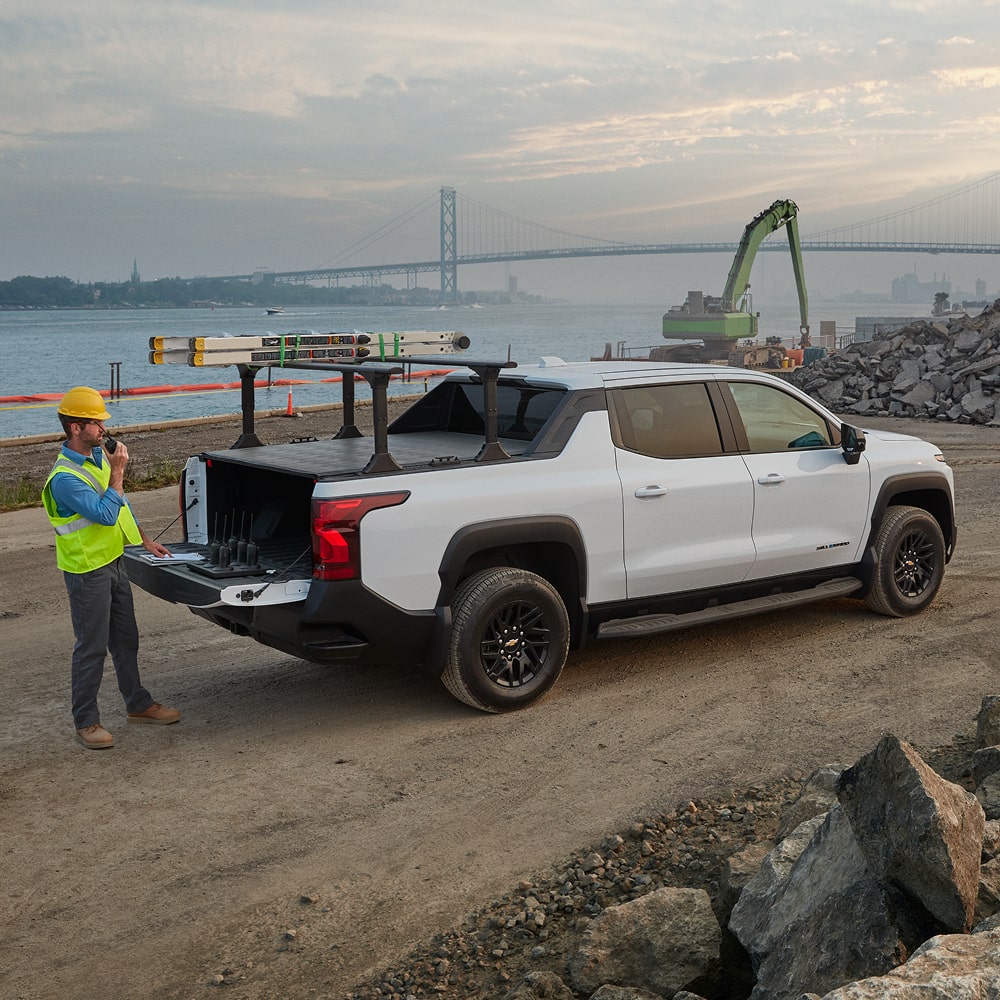 A Construction Worker Loading Equipment into the 2026 Chevy Commercial Silverado EV