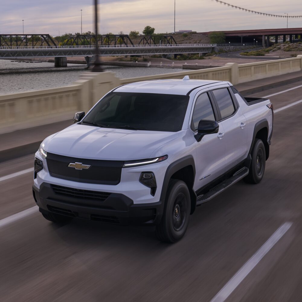 2026 Chevy Commercial Silverado EV Driving Over a Highway Bridge