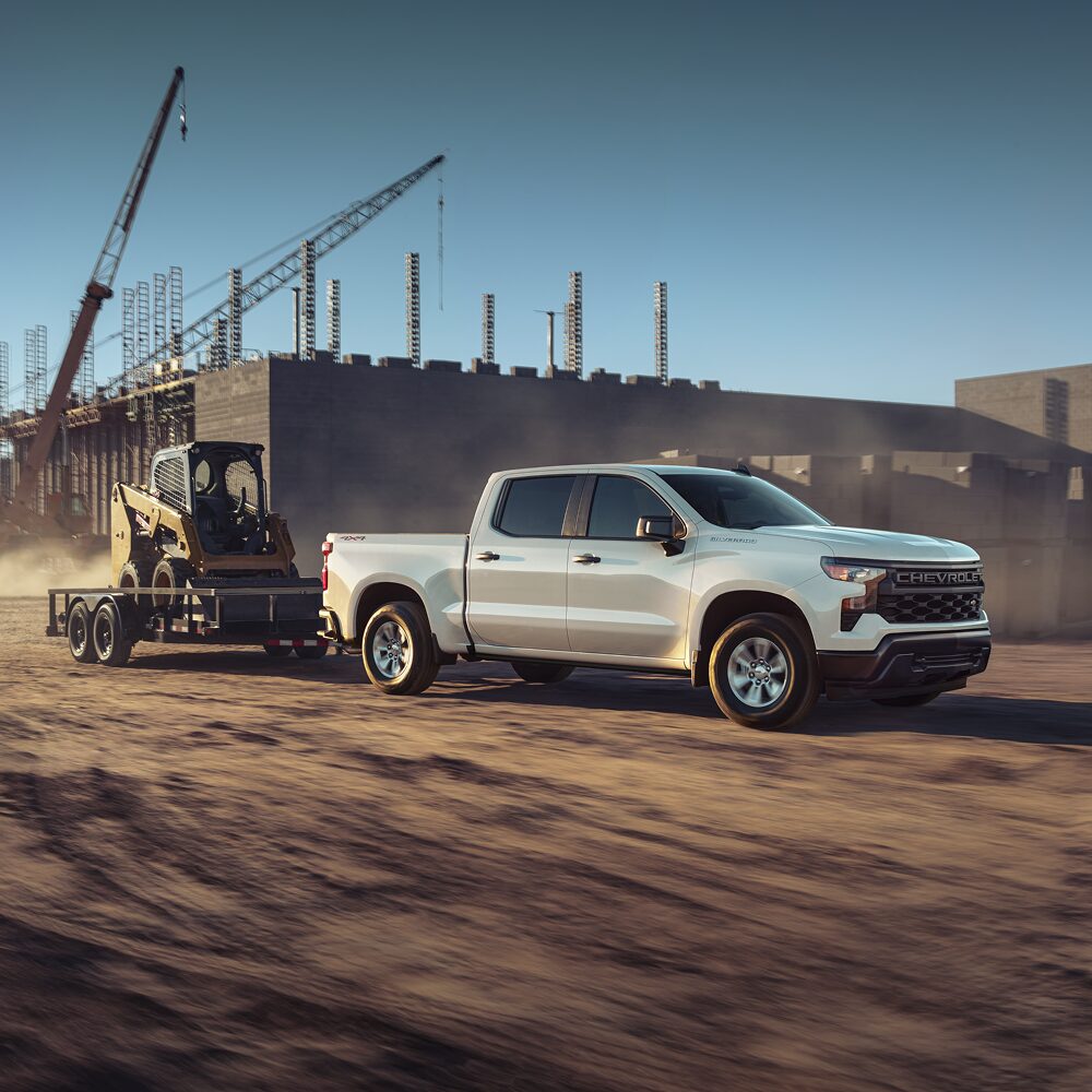 2026 Chevy Commercial Silverado Towing Construction Equipment at a Job Site
