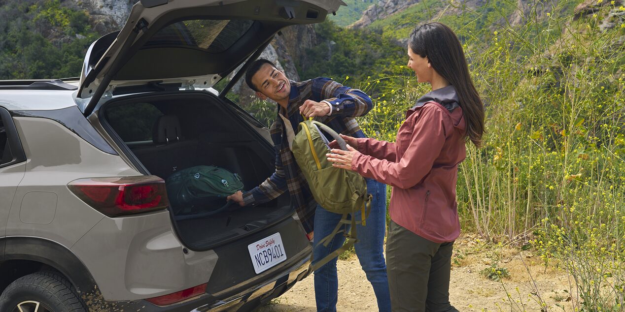 A Couple Unpacking Hiking Gear From the Trunk of Their 2026 Chevy Trailblazer
