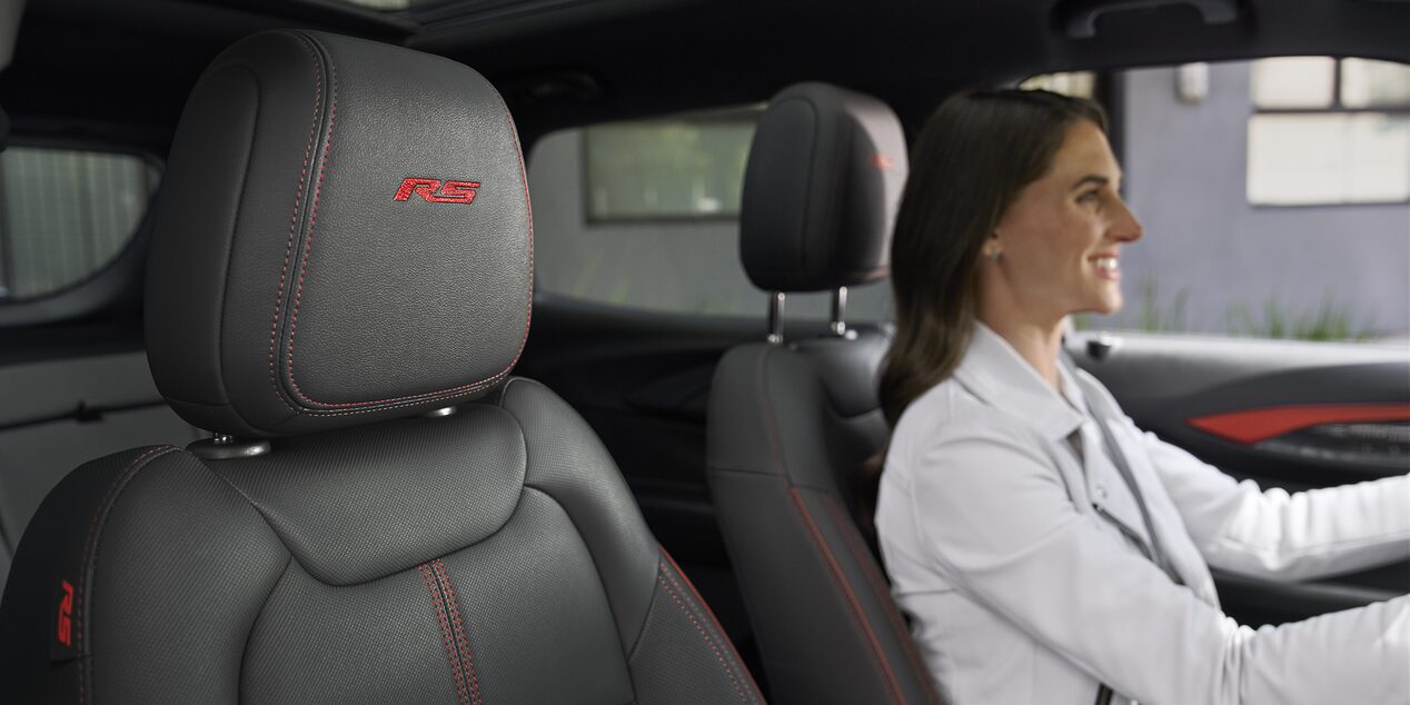 A Woman Smiling While Driving Her 2026 Chevy Trailblazer