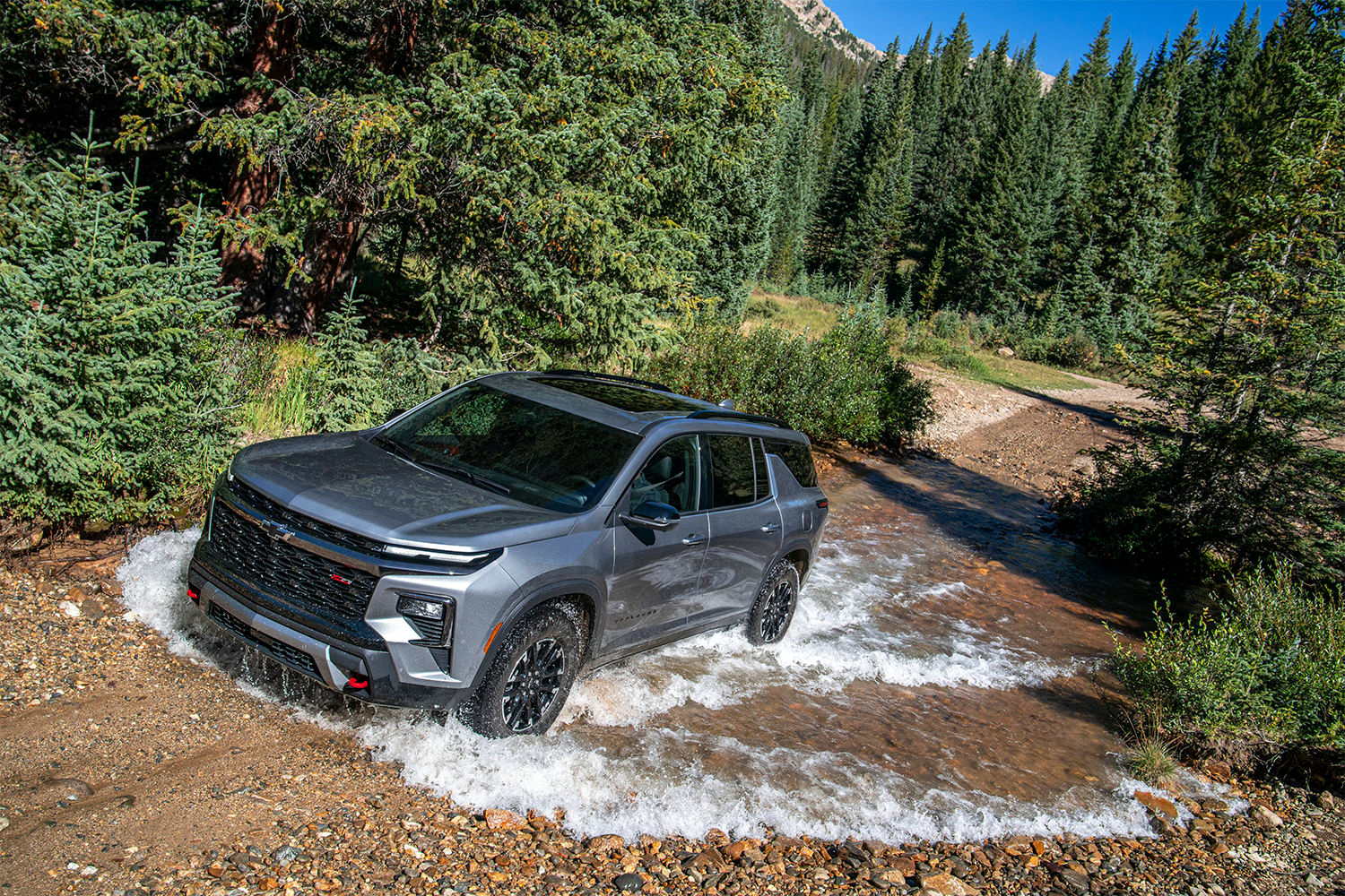 2026 Chevy Traverse Driving Through a Puddle in the Woods