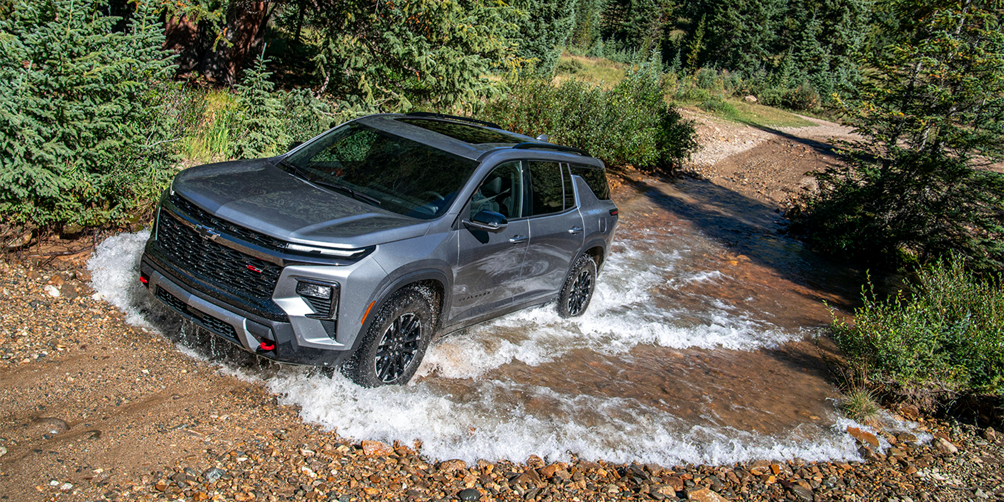 2026 Chevy Traverse Driving Through a Puddle in the Woods