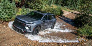 2026 Chevy Traverse Driving Through a Puddle in the Woods