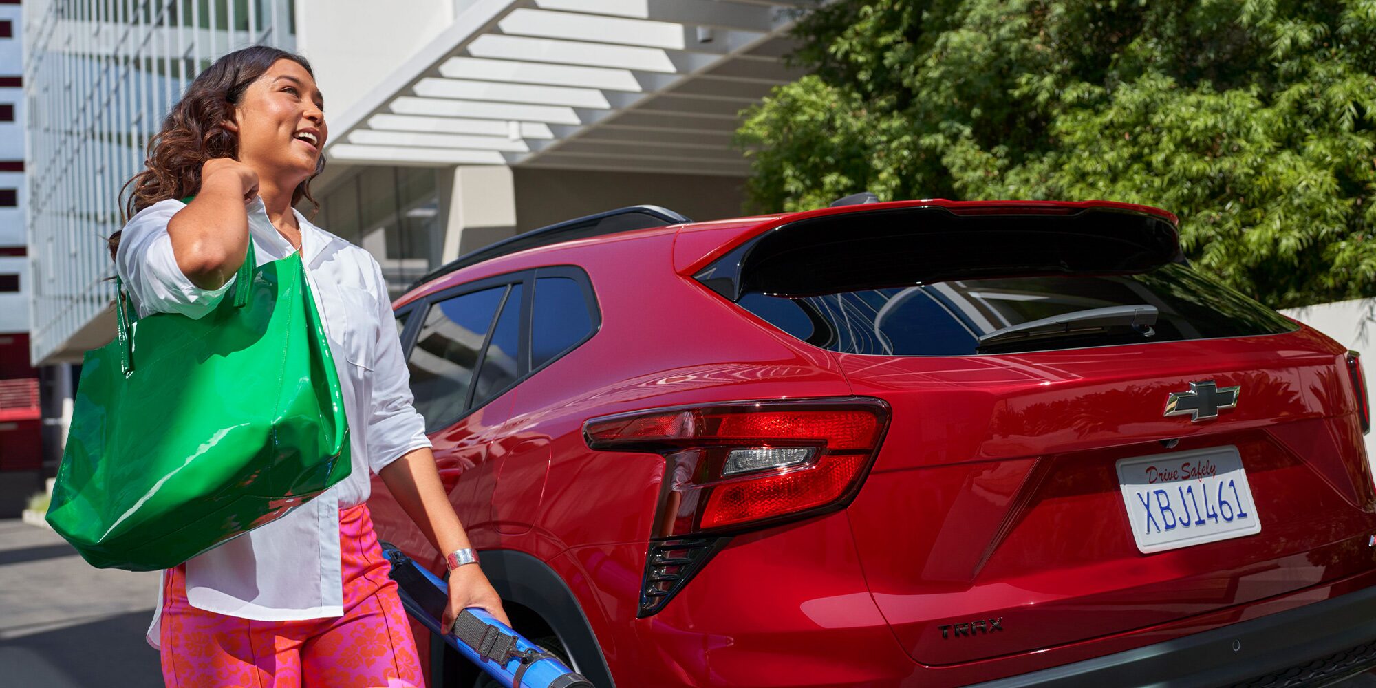 A Woman Walking Toward Her Parked 2026 Chevy Trax