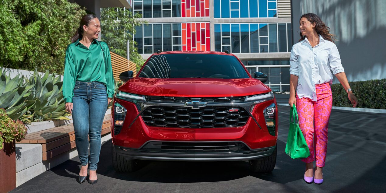 Two Women Walking Away from Their Parked 2026 Chevy Trax at a Mall