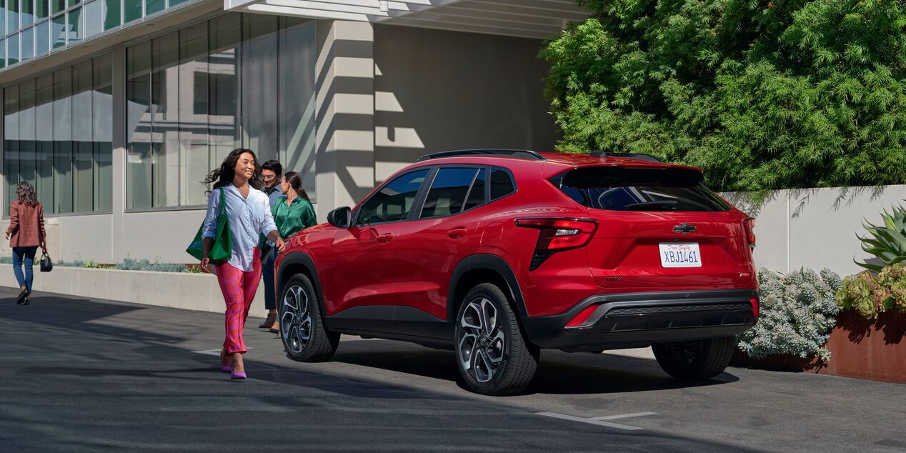A Woman Walking Toward Her Parked 2026 Chevy Trax