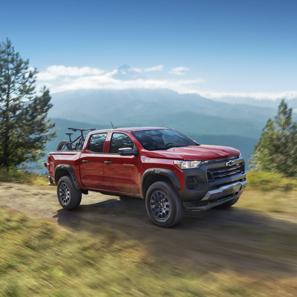 Three Quarters View of a Red 2026 Chevy Colorado Going through a Road at Mountain Top
