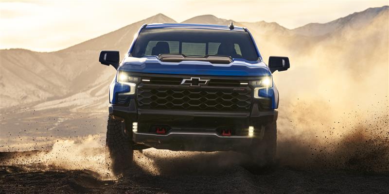 Front view of the 2026 Chevrolet Silverado LD Crew Cab ZR2 driving on a dusty terrain.
