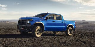 Side view of the 2026 Chevrolet Silverado LD Crew Cab ZR2 parked alone on a dirt terrain.