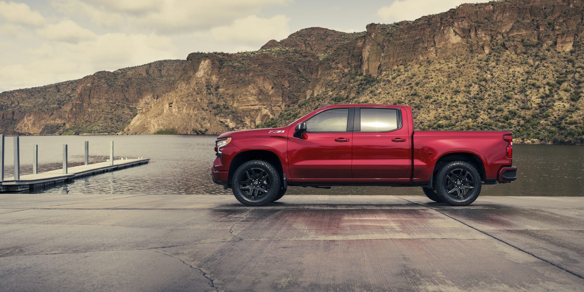 Side view of the 2026 Chevrolet Silverado LD Crew Cab RST parked by the docks.