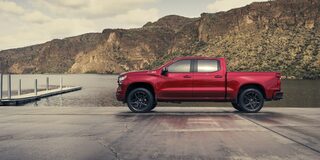 Side view of the 2026 Chevrolet Silverado LD Crew Cab RST parked by the docks.