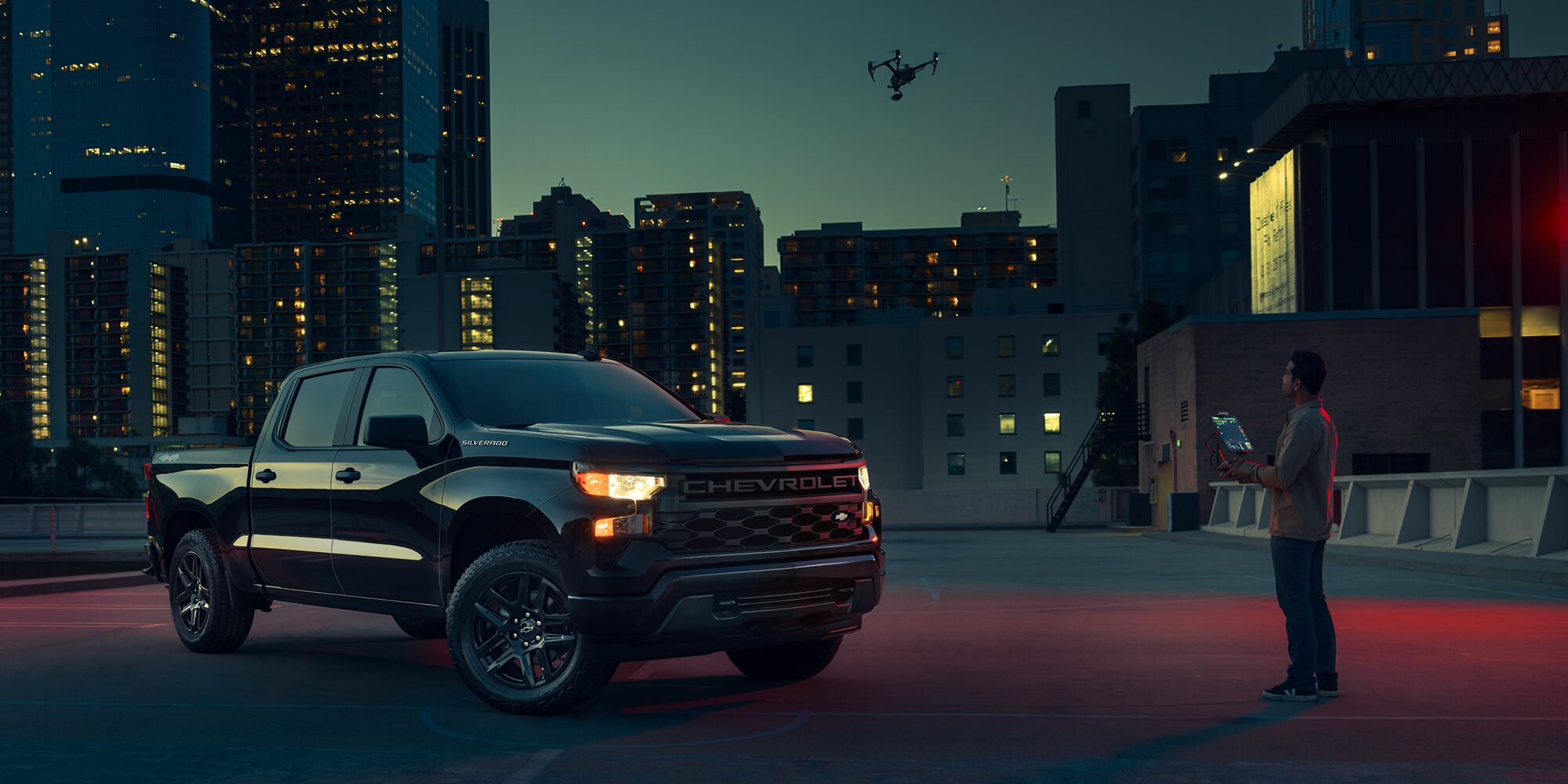 2026 Chevrolet Silverado LD Crew Cab parked outdoors at night.