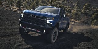2026 Chevrolet Silverado LD Crew Cab ZR2 driving on a dirt terrain.