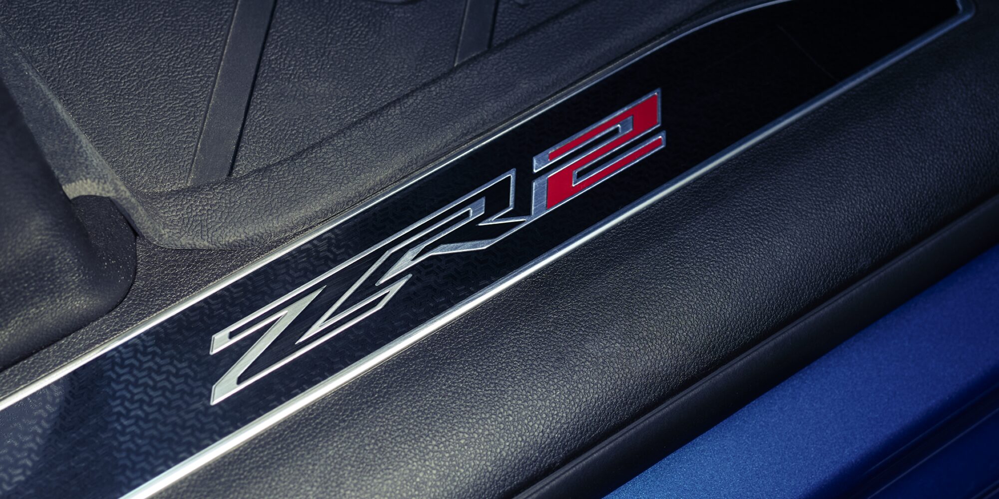 Close up view of the ZR2 logo etched on the sill plate of the 2026 Chevrolet Silverado LD Crew Cab ZR2.