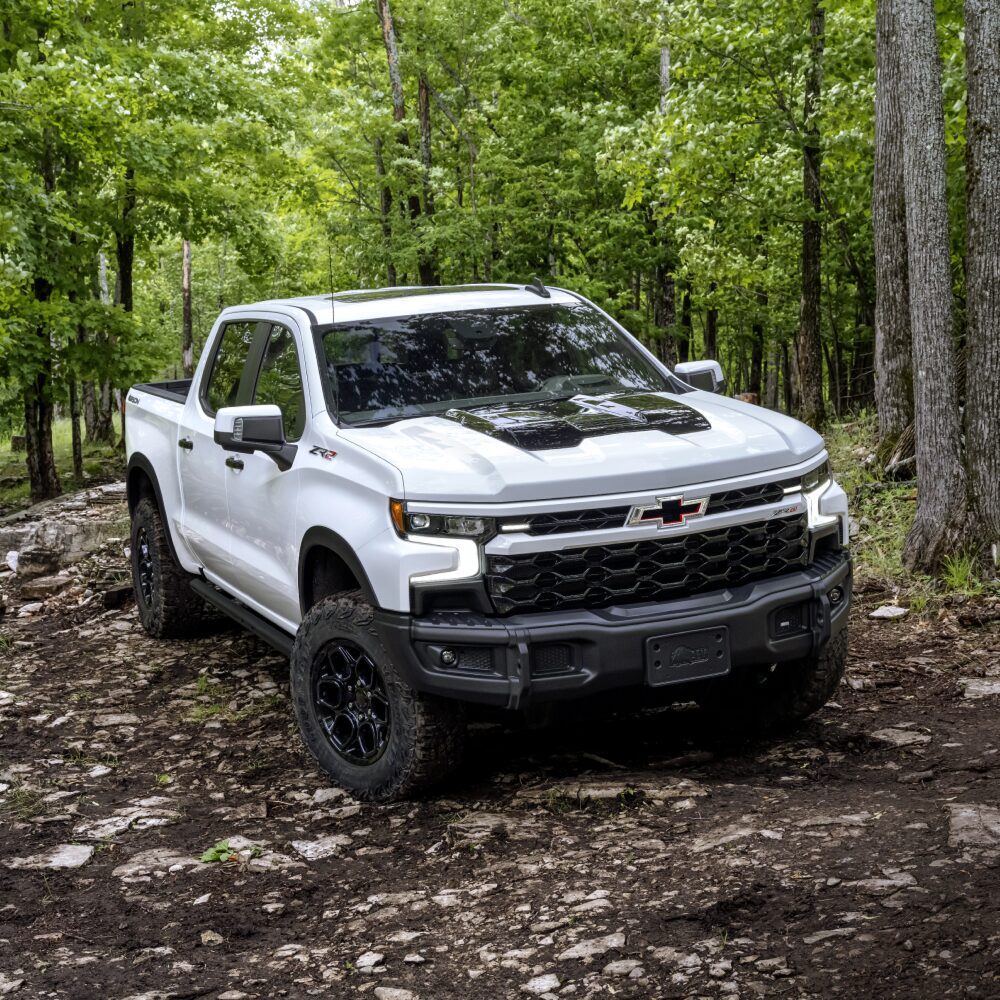 2026 Chevrolet Silverado LD driving through a forest.