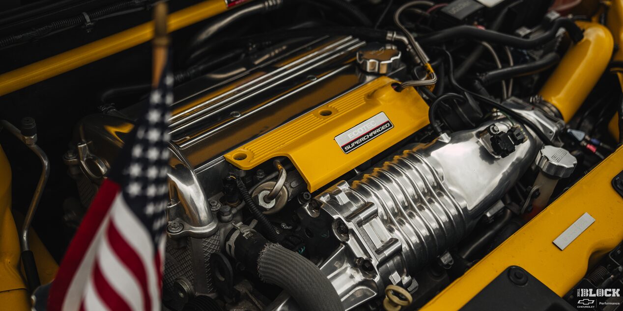 Close-up of a Yellow Engine with the American Flag in Front