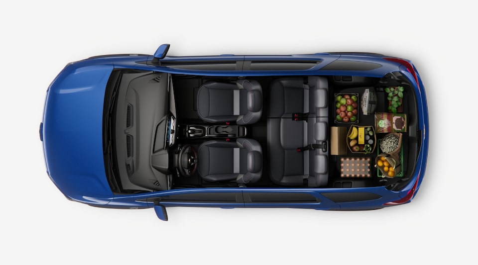 Imagem interna do novo Chevrolet Spin, com foco na versatilidade do espaço interno, mostrando a terceira fileira abaixada.
