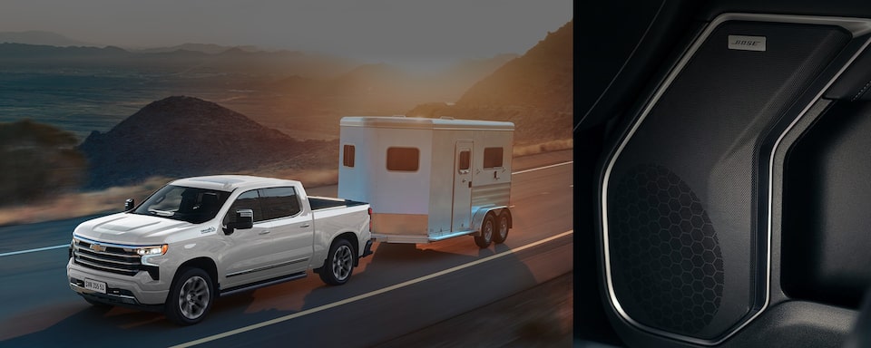 Imagem de uma Silverado na cor branca na estrada com um mini trailer engatado na traseira, com o som Bose em 1/3 da imagem.