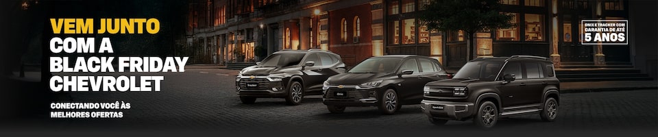 Três veículos Chevrolet - um Tracker, um Onix e um Spark EUV - estão estacionados em uma rua da cidade à noite. A imagem promove a campanha de Black Friday da Chevrolet. 