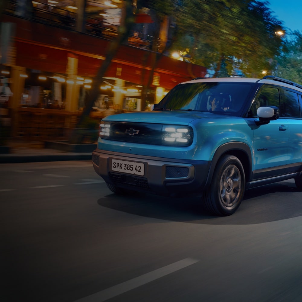 Chevrolet Spark EUV elétrico azul em movimento na cidade à noite