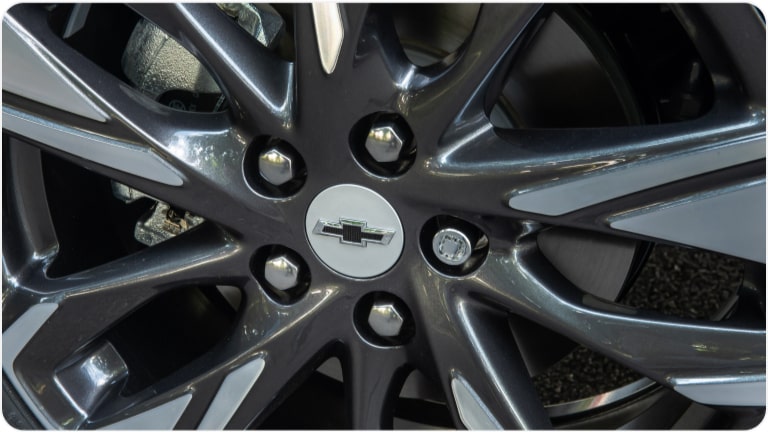 Calotinha de centro de roda de 16 na cor prata com emblema preto do Chevrolet Onix Plus para a respectiva página de acessórios.