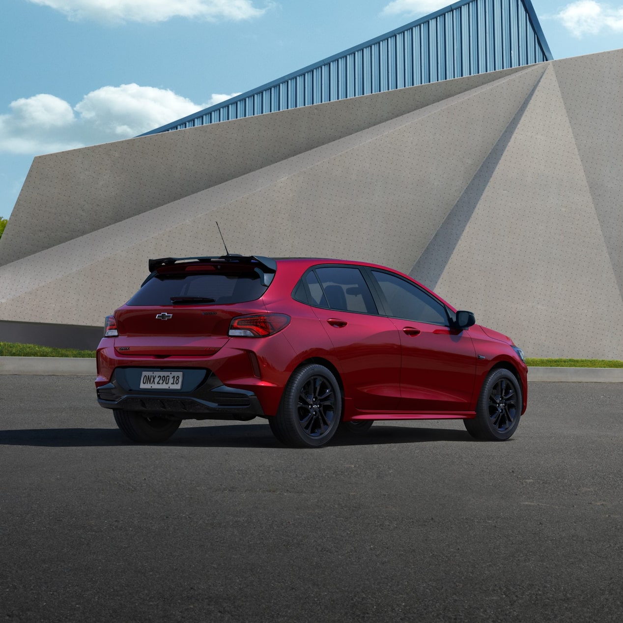 Chevrolet Onix RS Vermelho Scarlet de traseira em ambiente urbano moderno.