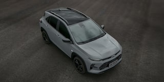 Chevrolet Sonic estacionado em uma área externa. Vemos a superior do carro, com destaque para o teto, rack de teto e capô.​