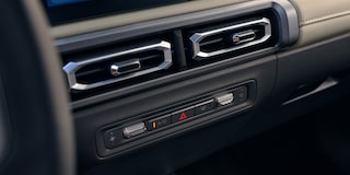 Close no painel do Spark EUV com foco nas saídas de ar e botões de controle de temperatura e segurança.