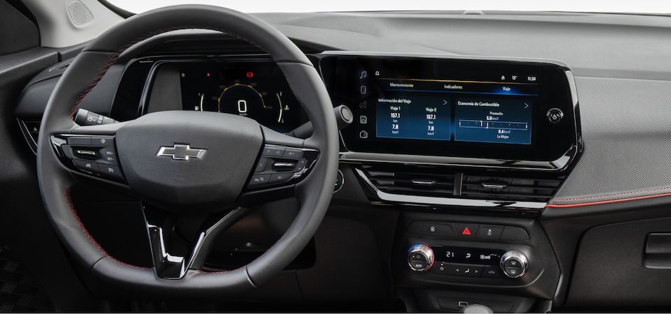 Painel central da Chevrolet Montana com volante, cluster digital e multimídia MyLink em destaque com fundo branco
