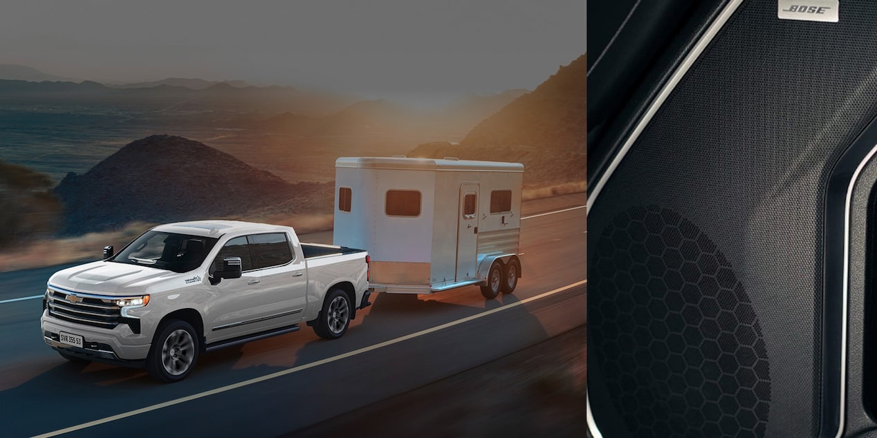 Imagem de uma Silverado na cor branca na estrada com um mini trailer engatado na traseira, com o som Bose em 1/3 da imagem.
